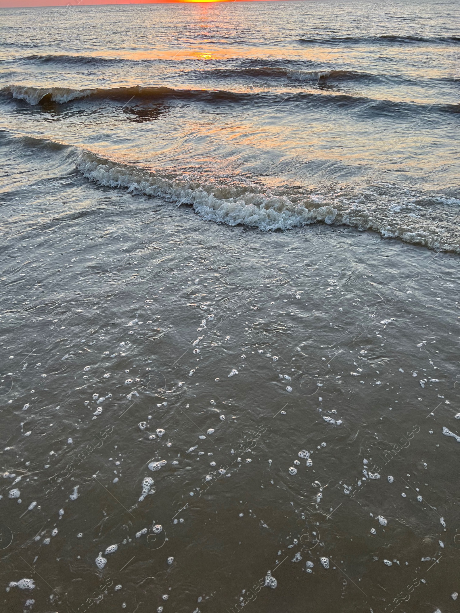 Photo of Beautiful view of sea waves at sunset