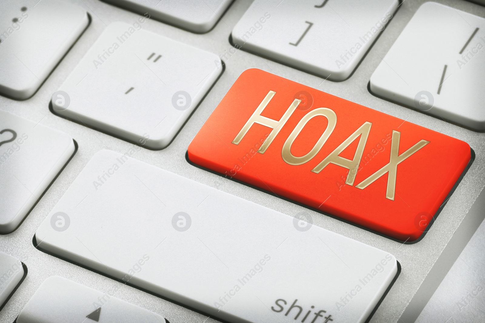 Image of Red button with word Hoax on laptop keyboard, closeup