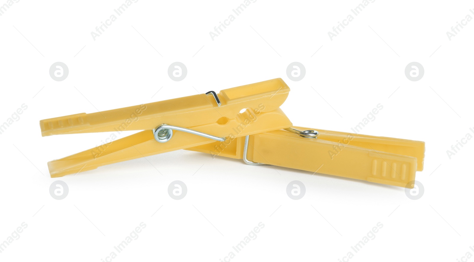 Photo of Bright yellow plastic clothespins on white background