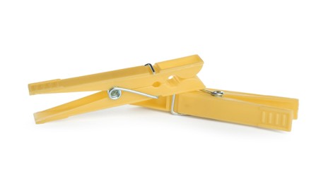 Bright yellow plastic clothespins on white background