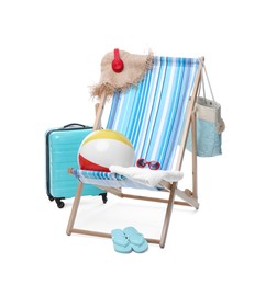 Photo of Deck chair, suitcase and beach accessories isolated on white