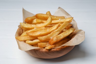 Bowl of french fries on white wooden table