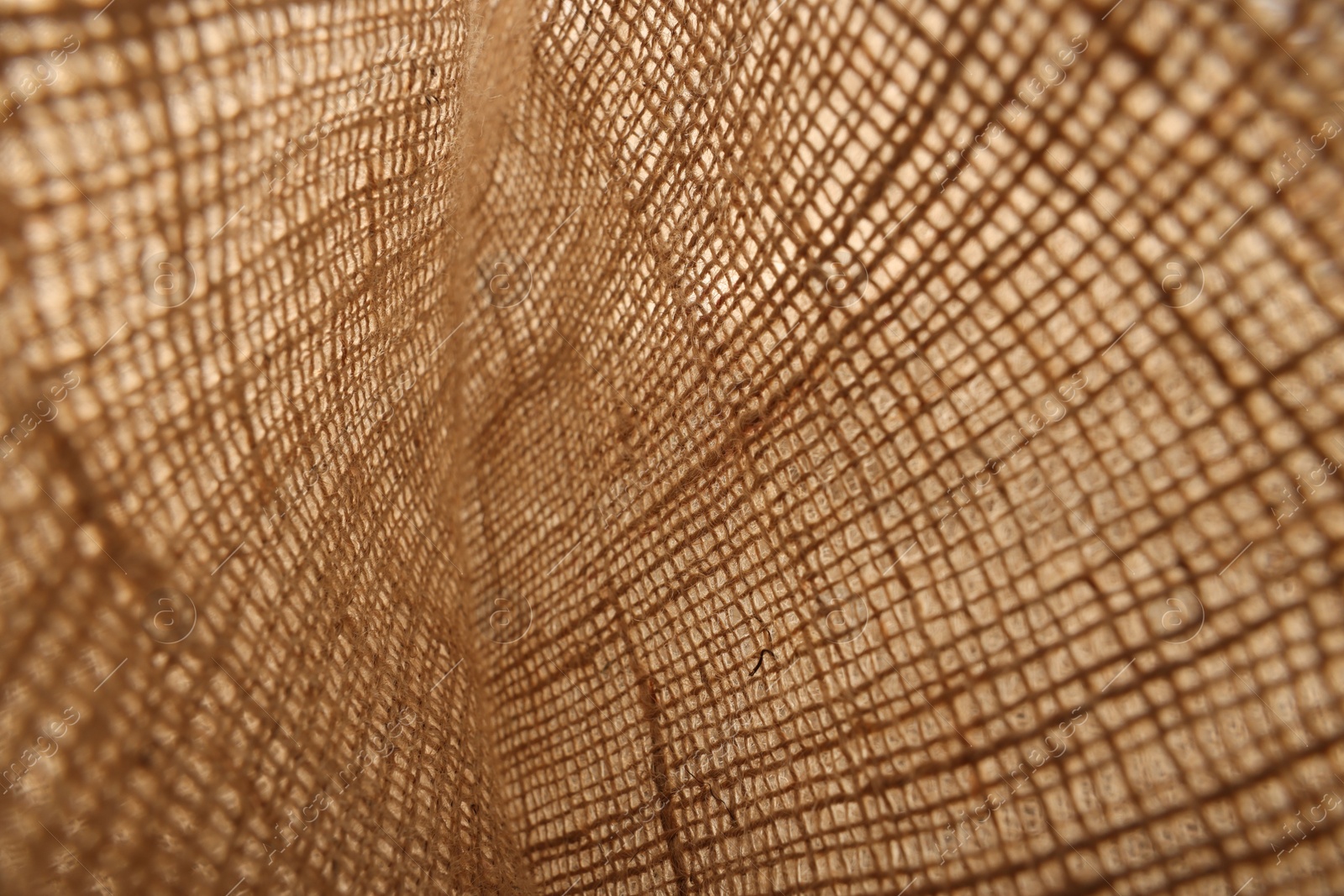 Photo of Texture of natural burlap fabric as background, closeup