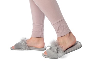 Photo of Woman in grey soft slippers on white background, closeup