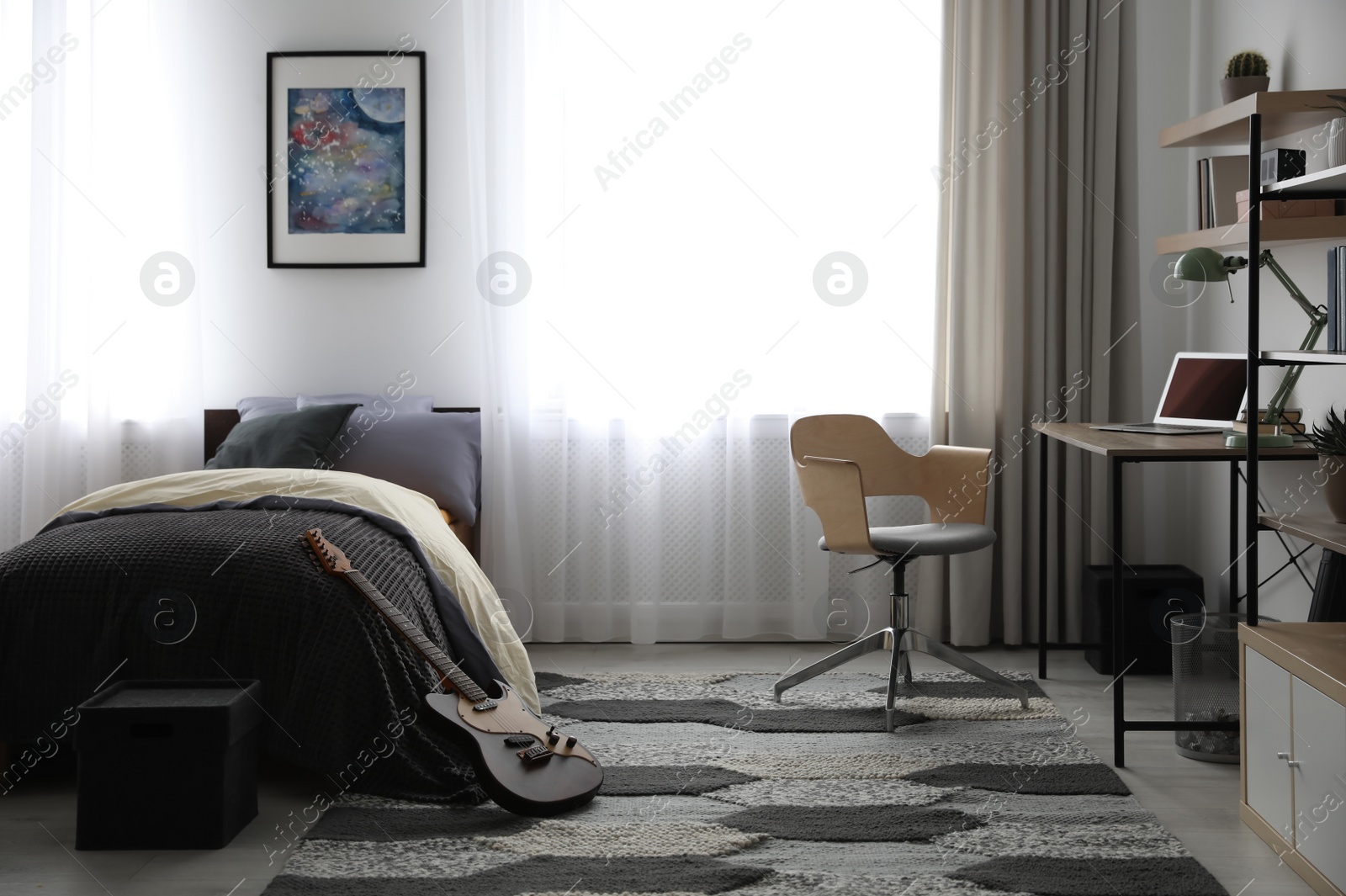 Photo of Modern teenager's room interior with workplace and bed