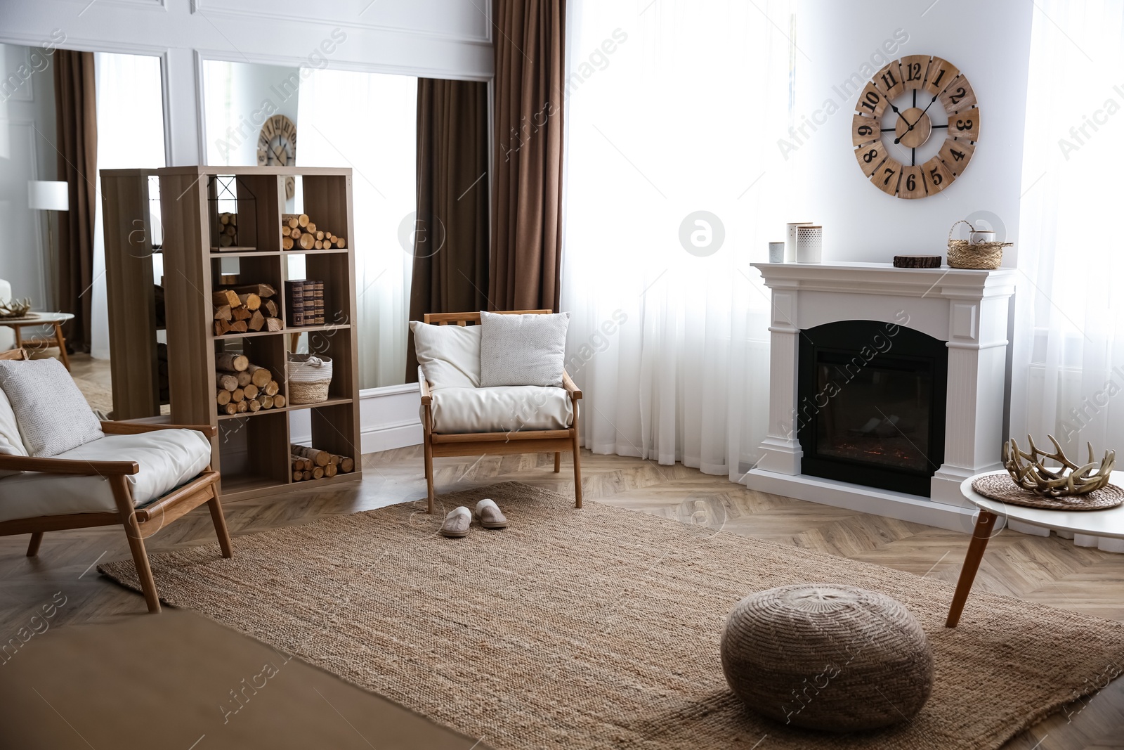 Photo of Elegant artificial fireplace and armchairs in room. Interior design