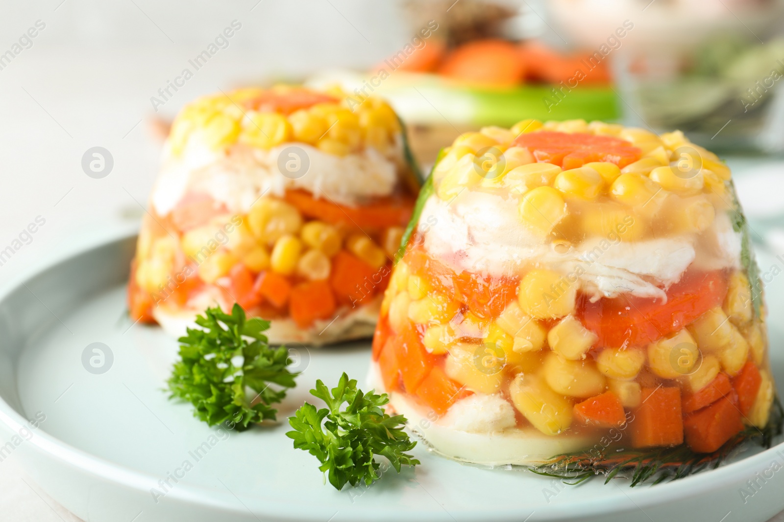 Photo of Delicious fish aspic with vegetables on plate, closeup