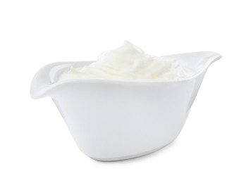 Delicious sour cream in gravy boat on white background