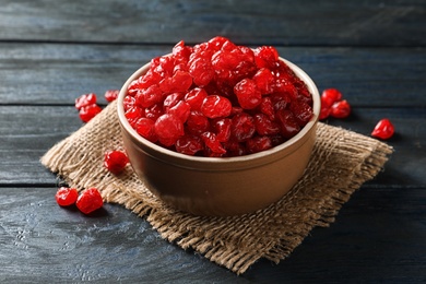 Photo of Bowl with tasty cherries on wooden background. Dried fruits as healthy food