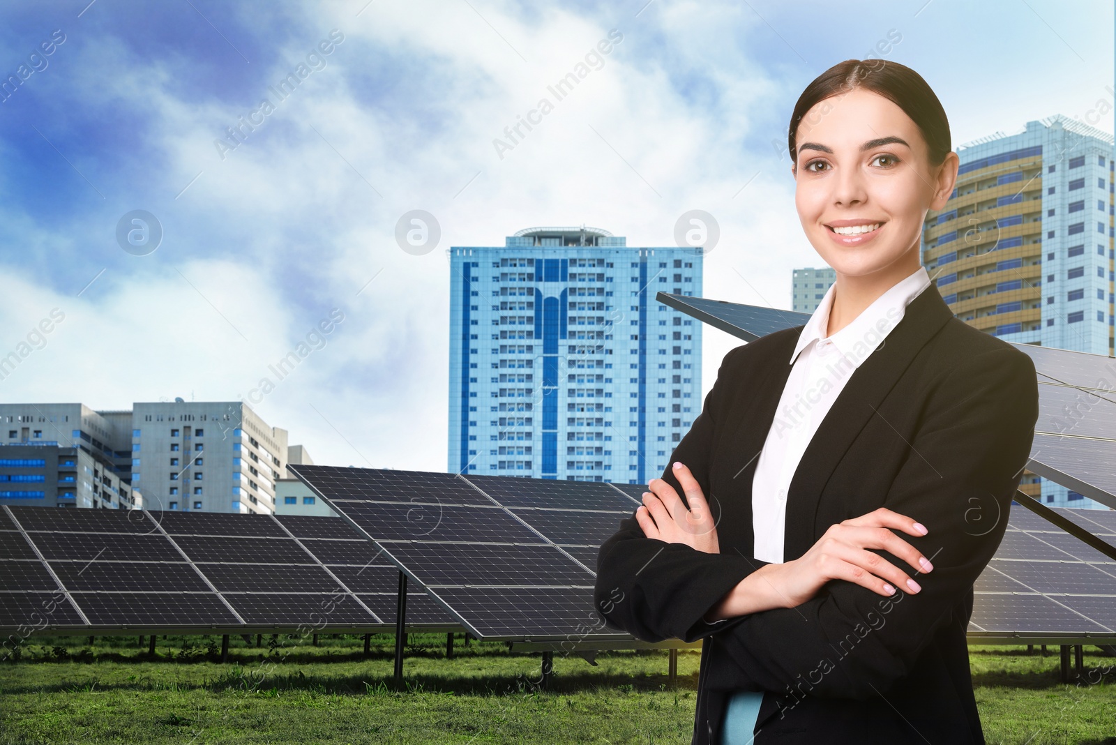 Image of Young businesswoman near solar panels and beautiful view of cityscape. Alternative energy source