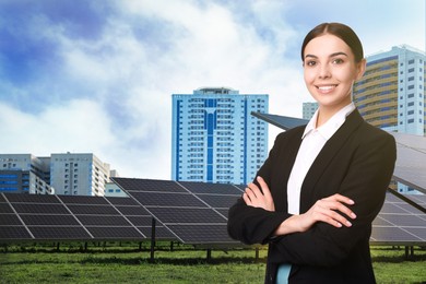Young businesswoman near solar panels and beautiful view of cityscape. Alternative energy source
