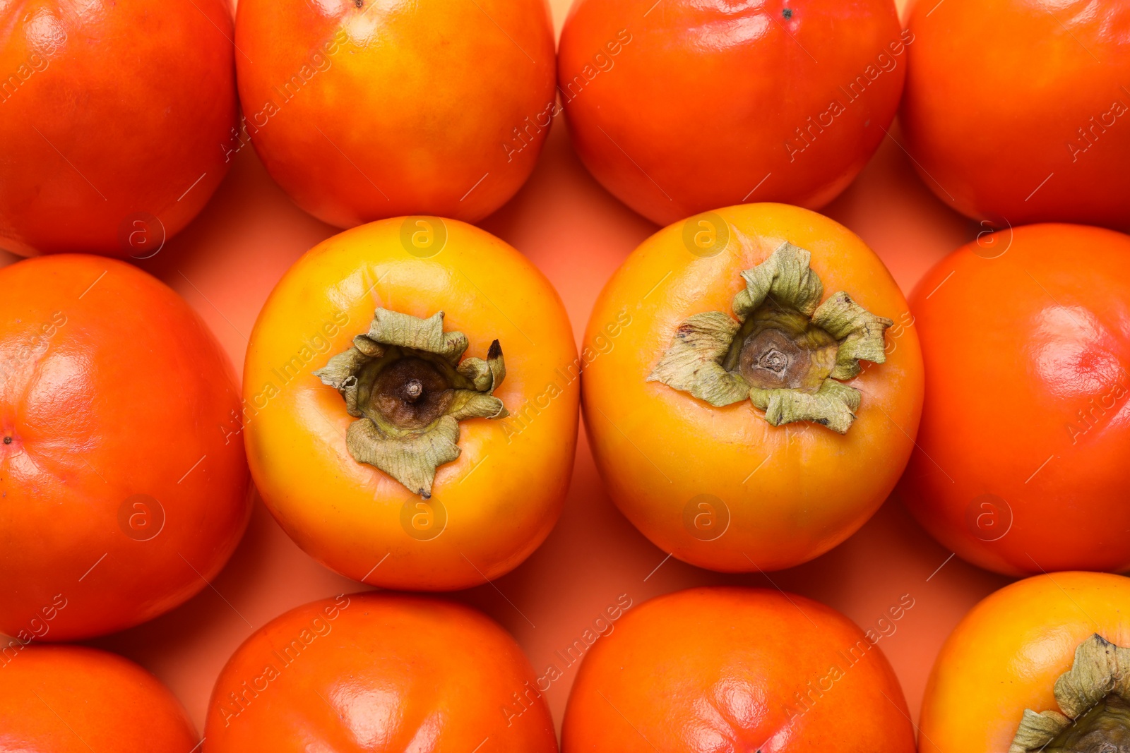 Photo of Delicious ripe juicy persimmons as background, top view