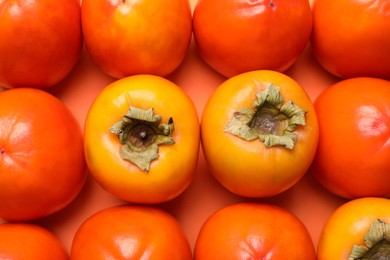 Photo of Delicious ripe juicy persimmons as background, top view