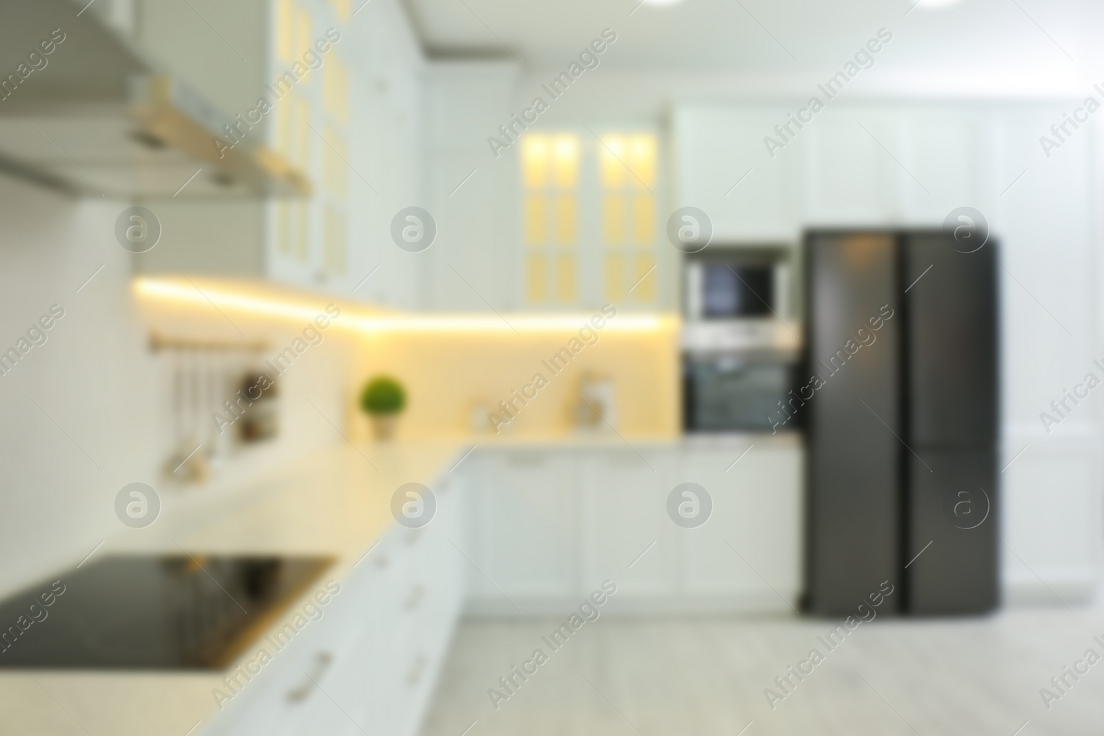 Photo of Blurred view of modern kitchen interior with stylish furniture