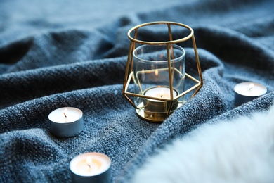 Photo of Beautiful burning candles on fabric. Time to relax