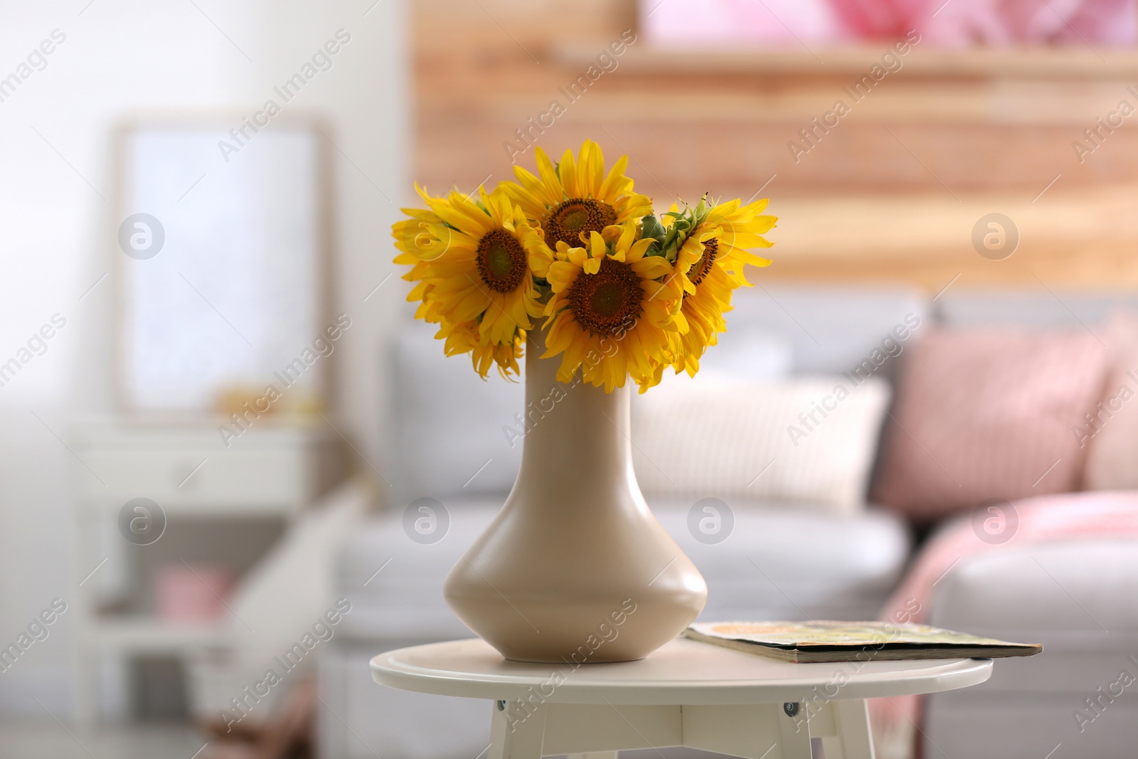 Photo of Beautiful bouquet of sunflowers in vase on white table indoors