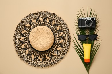 Photo of Flat lay composition with straw hat on beige background