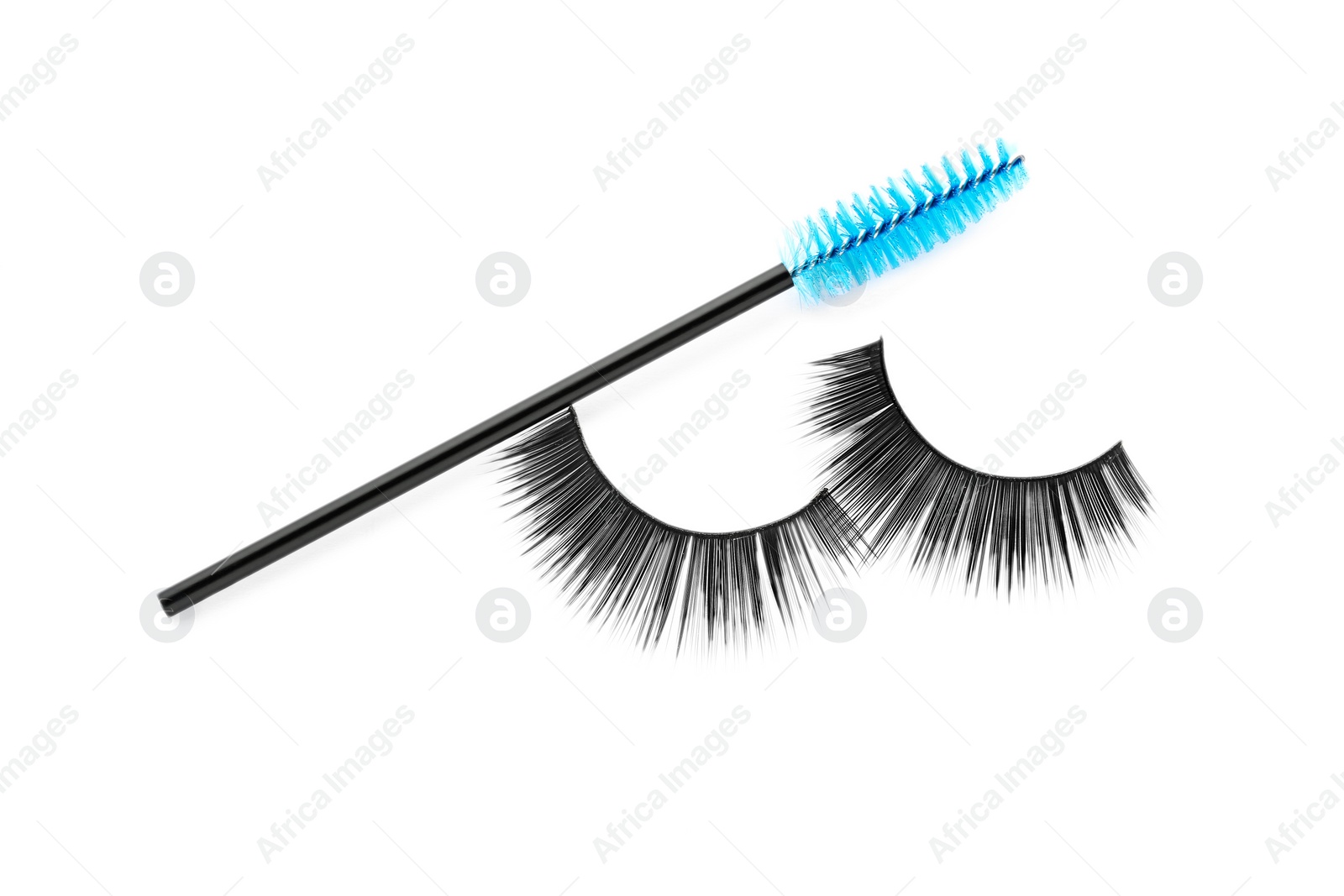 Photo of Fake eyelashes and brush on white background, top view