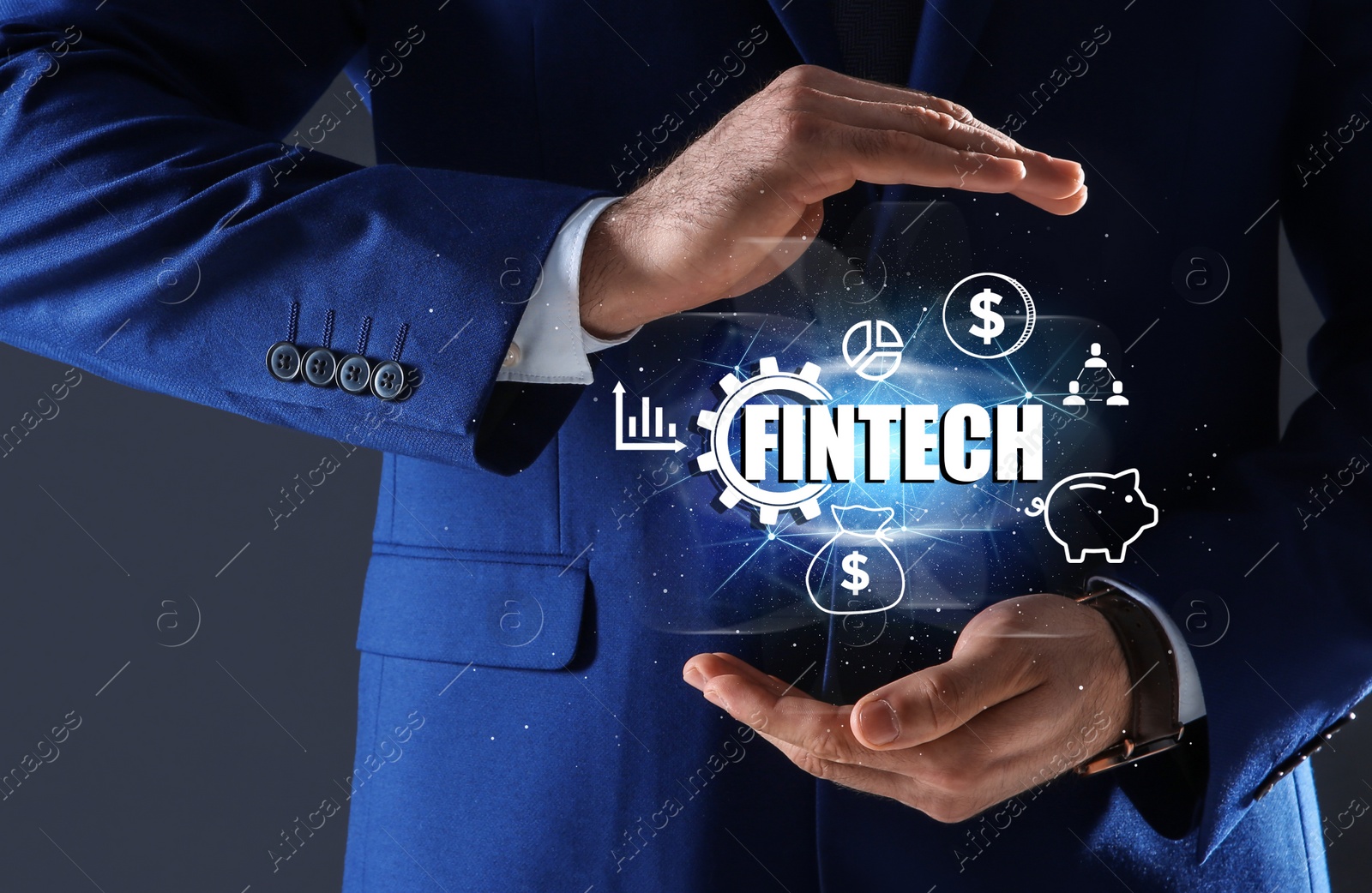Image of Fintech concept. Man demonstrating different icons on dark background, closeup