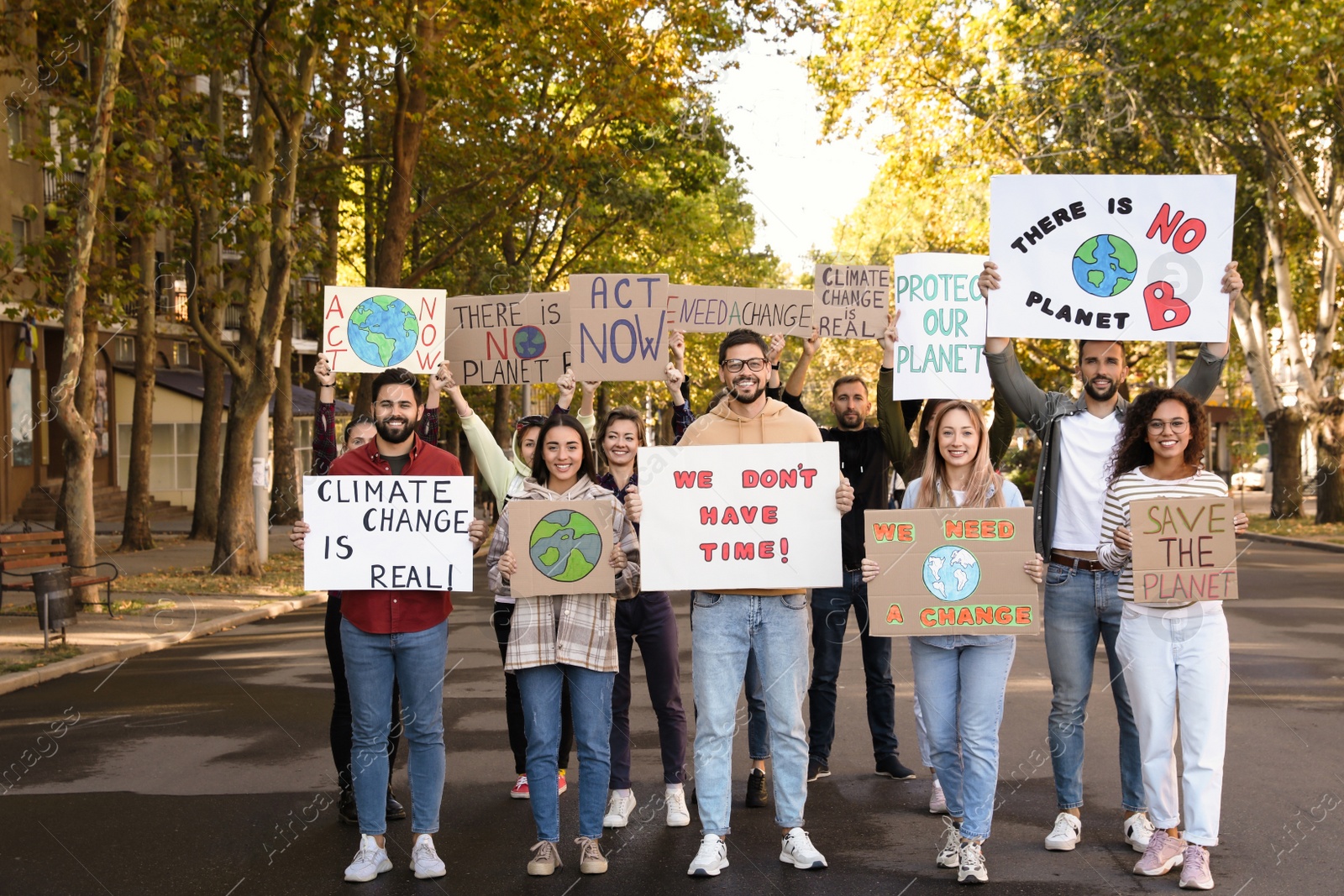 Photo of Group of people with posters protesting against climate change on city street