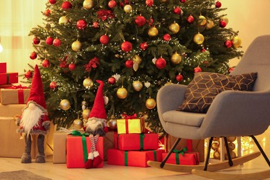 Photo of Beautifully wrapped gifts under Christmas tree in room. Festive interior design