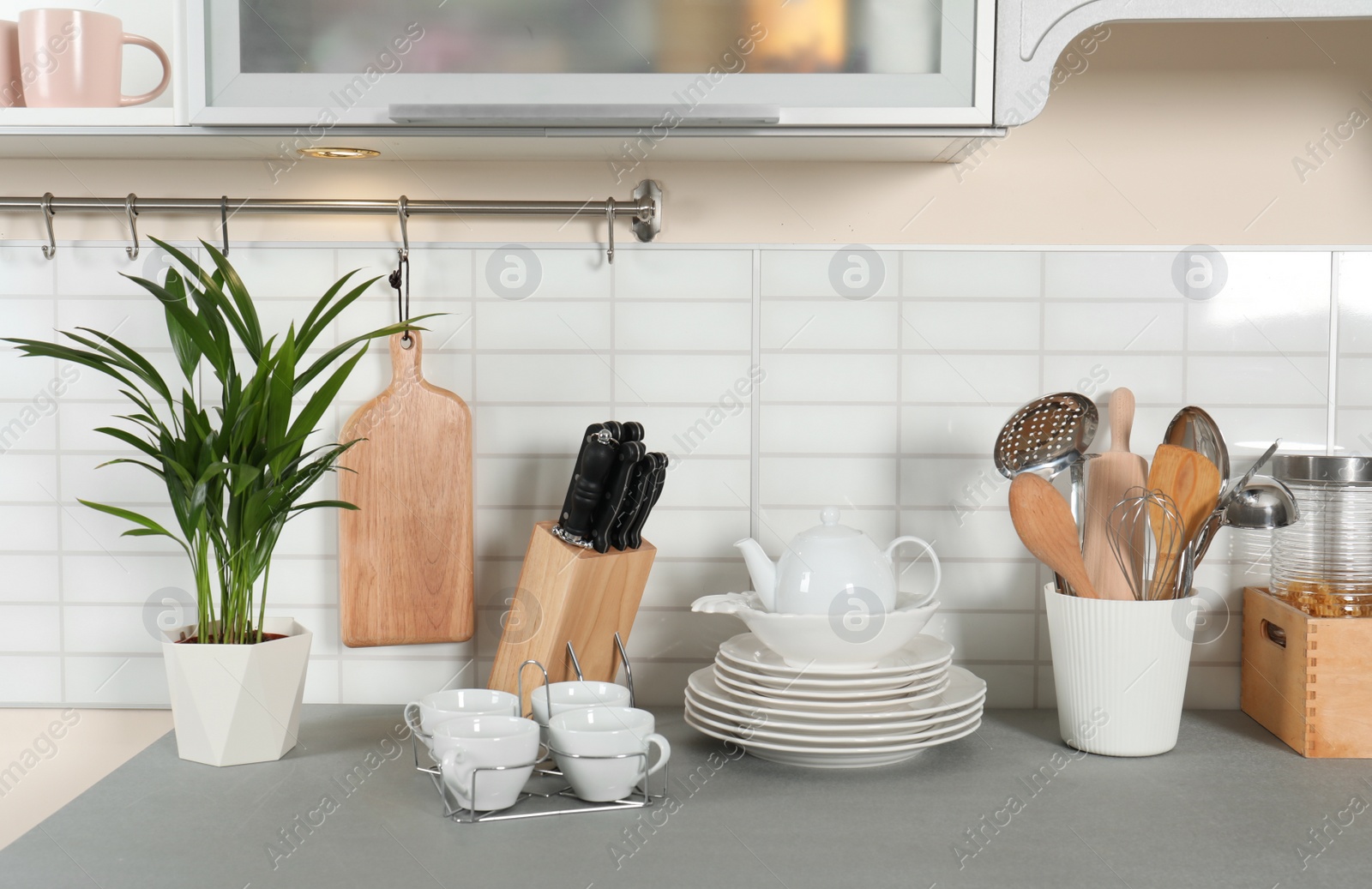 Photo of Clean dishes and utensils on kitchen counter