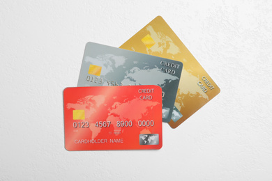 Photo of Credit cards on white table, flat lay