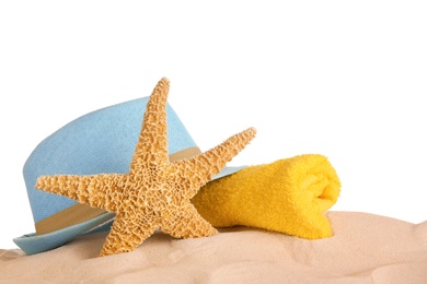 Photo of Beach accessories on sand against white background