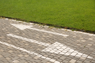 Photo of Bicycle lane with marking near park on sunny day