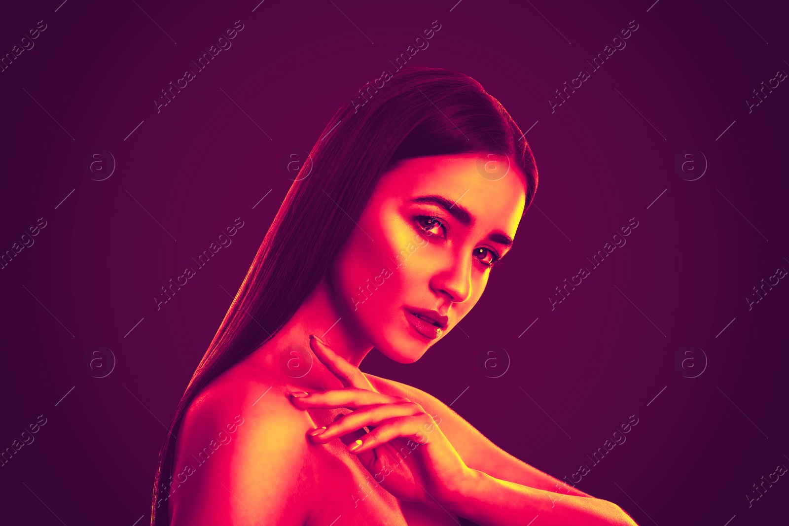 Image of Portrait of beautiful woman posing in neon lights