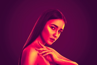 Portrait of beautiful woman posing in neon lights