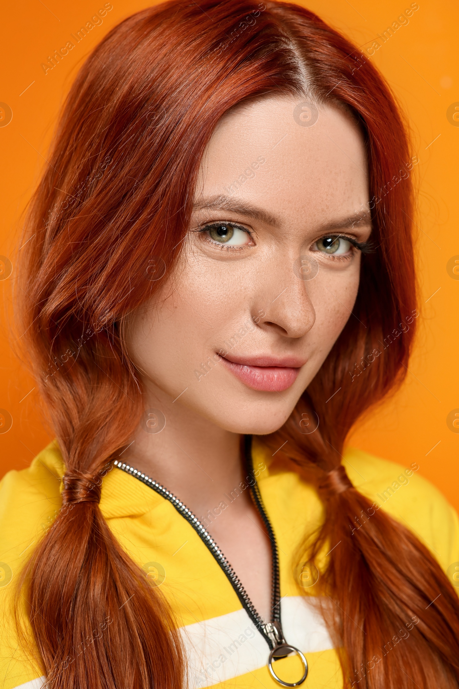 Photo of Portrait of beautiful woman on orange background