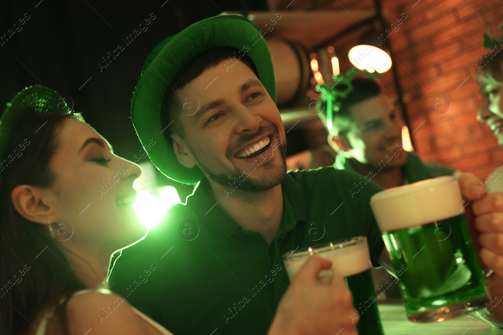 Photo of Couple with beer celebrating St Patrick's day in pub