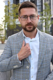 Photo of Portrait of handsome bearded man in glasses outdoors