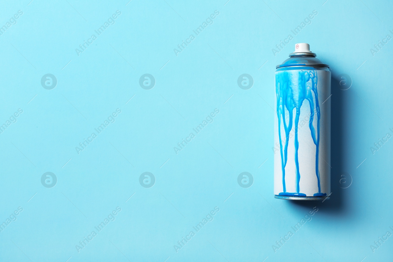 Photo of Used can of spray paint on color background, top view. Space for text