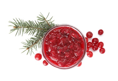 Photo of Bowl of cranberry sauce with fir tree branches on white background, top view