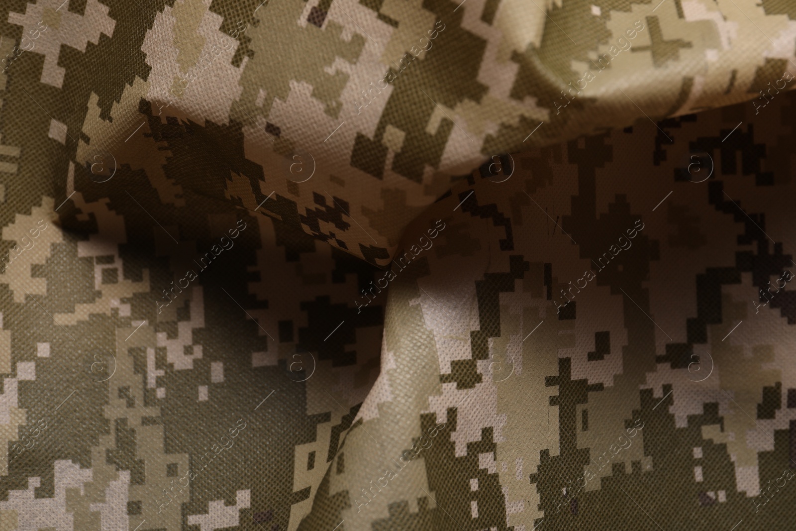 Photo of Texture of crumpled camouflage fabric as background, closeup