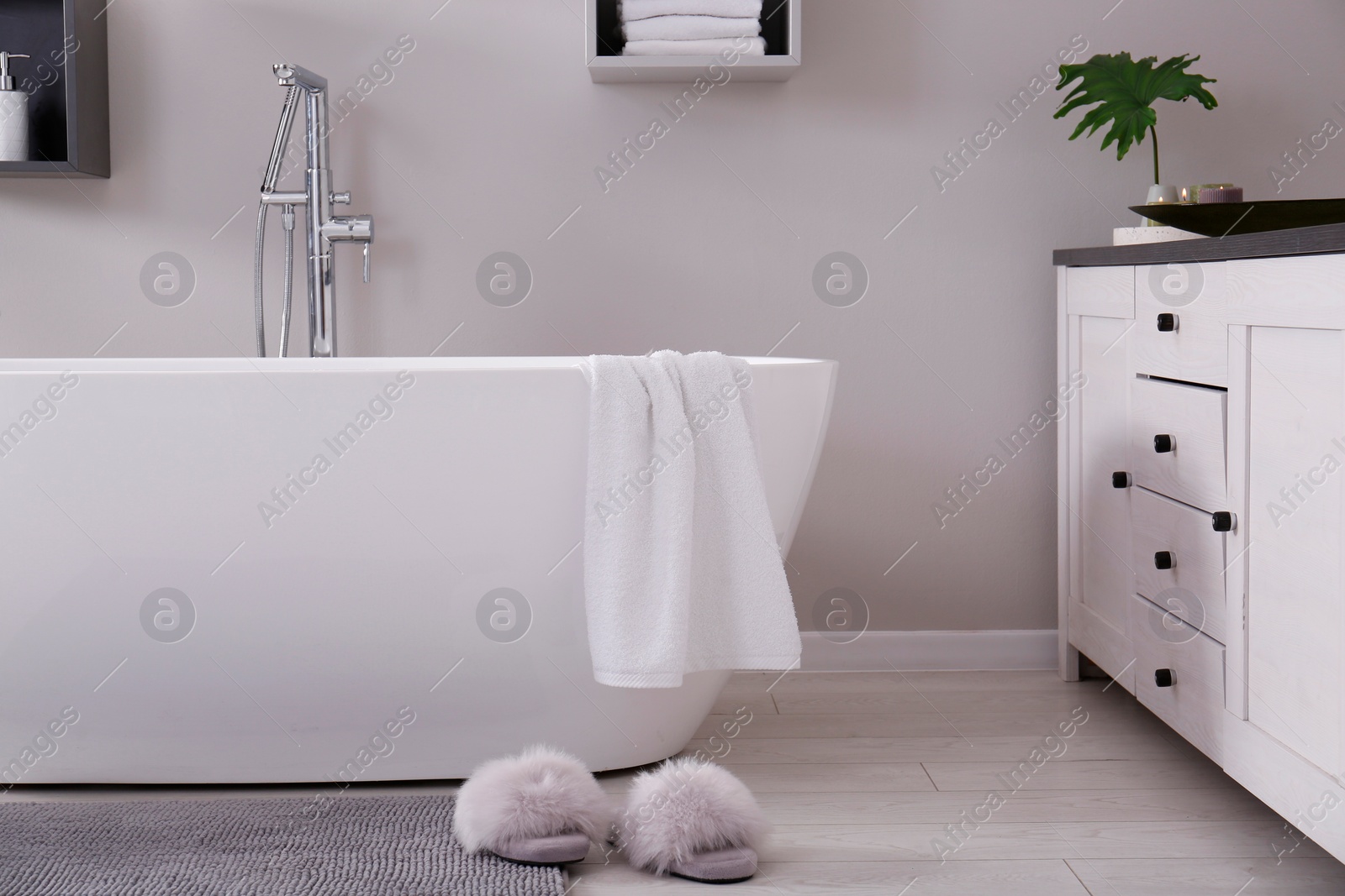 Photo of Stylish bathroom interior with modern white tub