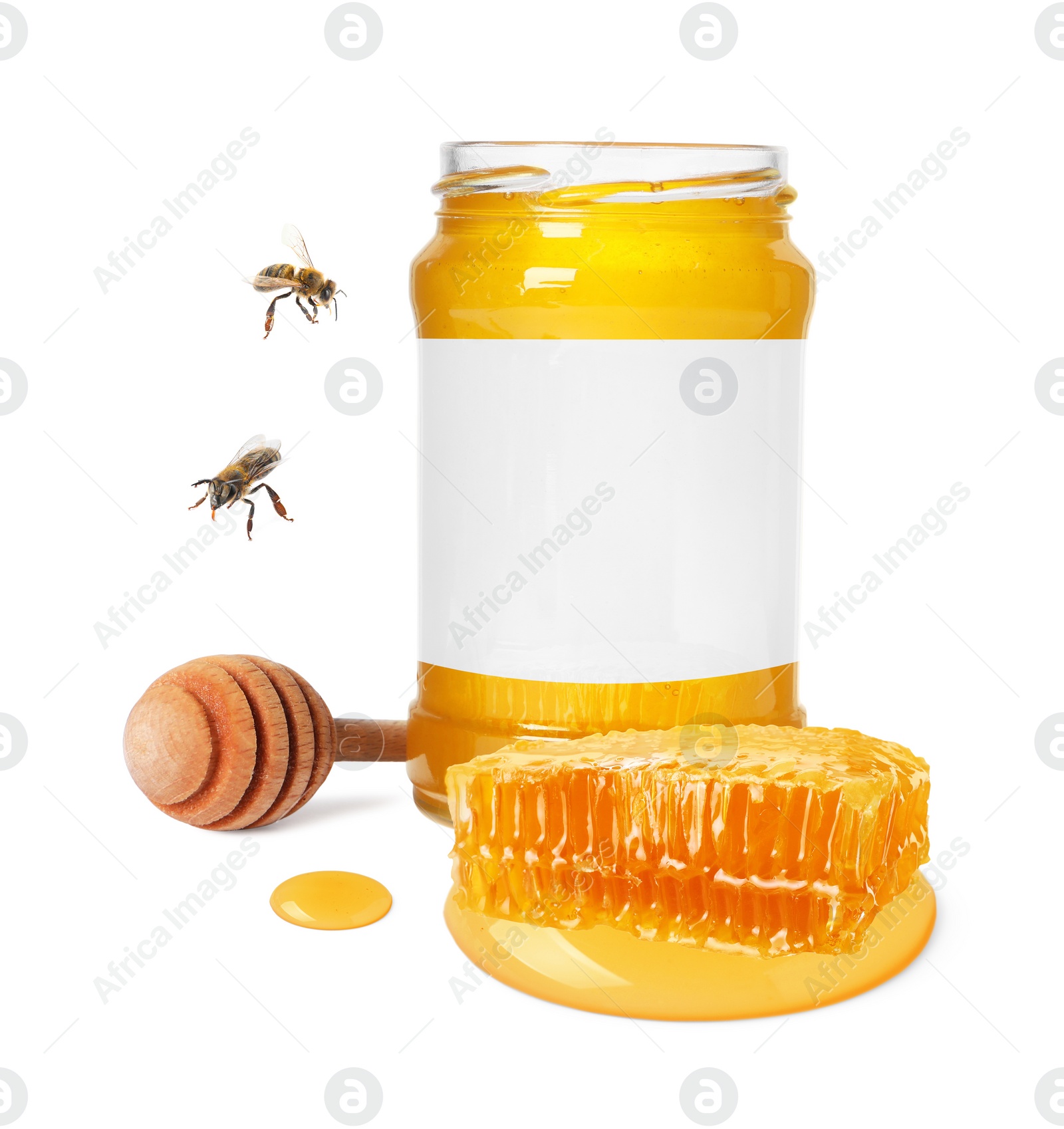 Image of Sweet honey in glass jar with blank label, wooden honey dipper, piece of honeycomb and and flying bees on white background. Mockup for design