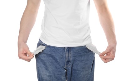Poor man showing empty pockets on white background, closeup