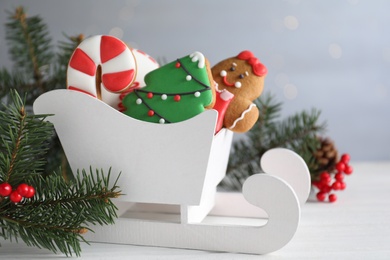 Photo of Decorated Christmas cookies on white wooden table