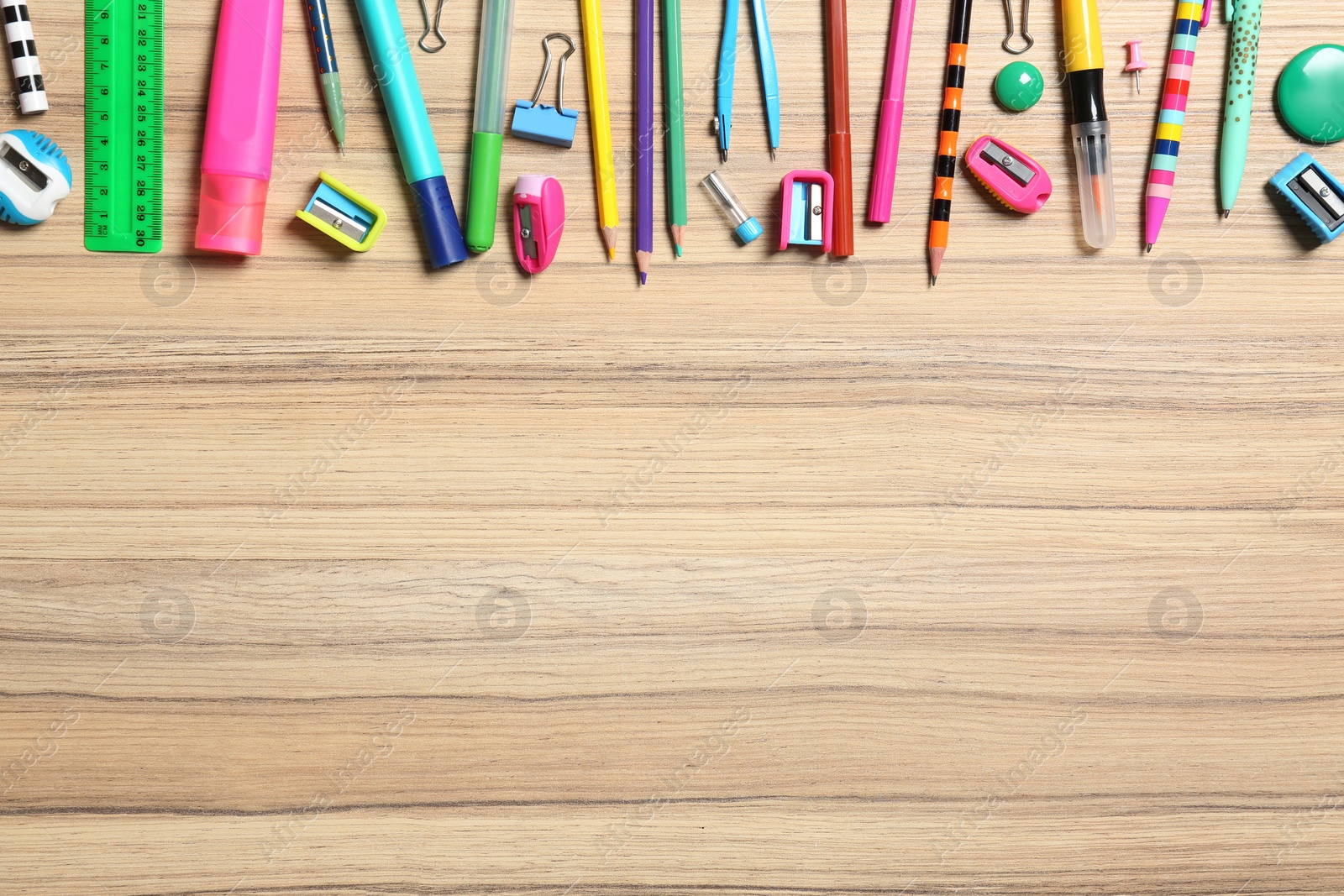 Photo of Flat lay composition with different stationeries on wooden background, space for text