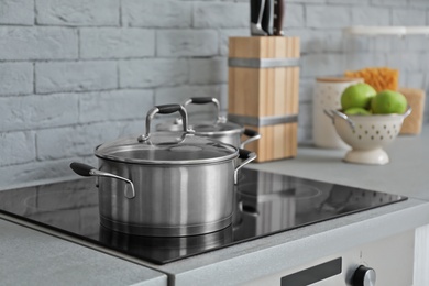 Photo of Saucepan on electric stove in modern kitchen