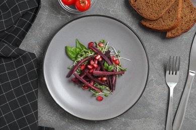 Photo of Delicious fresh carrot salad served on grey table, flat lay