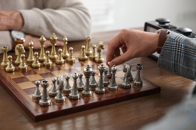 Photo of Men playing chess during tournament at table, closeup