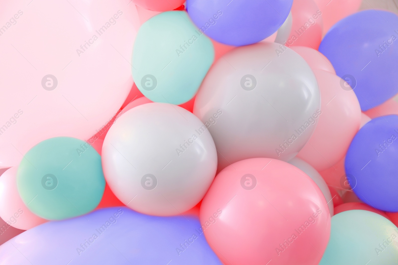 Image of Beautiful colorful balloons on light background, closeup. Party decor 