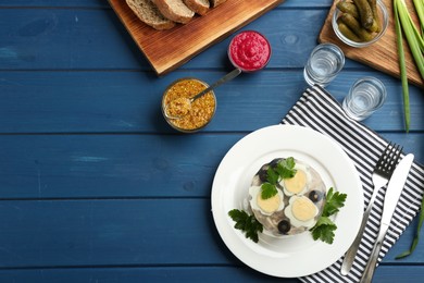 Delicious aspic with meat served on blue wooden table, flat lay. Space for text