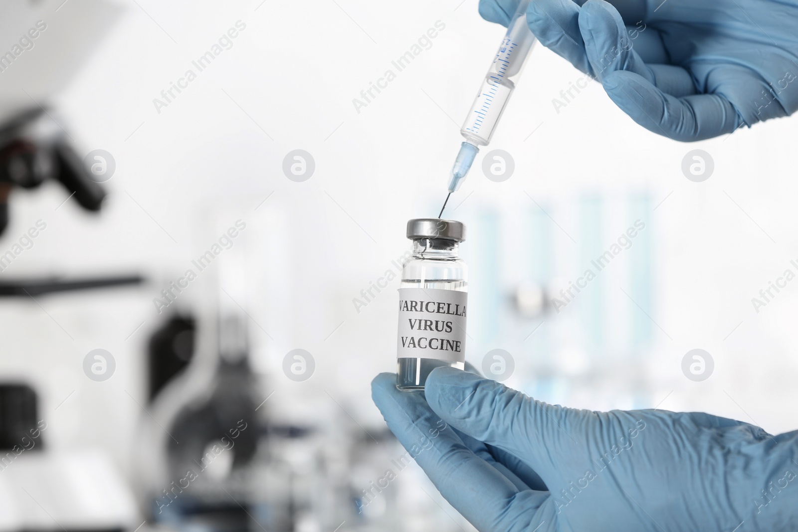 Photo of Doctor filling syringe with chickenpox vaccine indoors, closeup. Varicella virus prevention