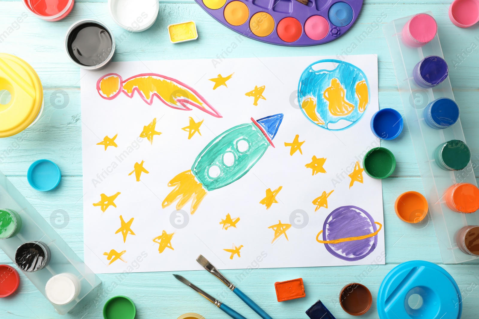 Photo of Flat lay composition with child's painting of spaceship on table