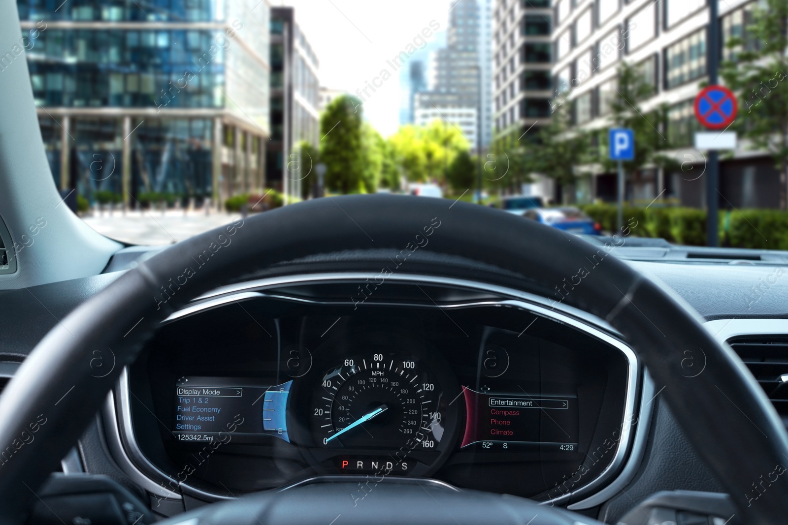 Image of Dashboard with speedometer behind steering wheel inside car